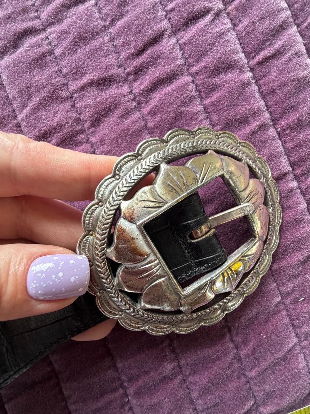 belt with a silver buckle featuring a floral Western-style pattern